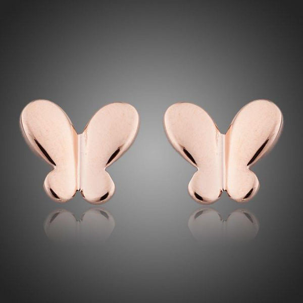 KHAISTA rose gold butterfly earrings on white background