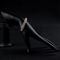 Close up detail of KHAISTA rose gold classic bangle