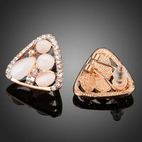 Side angle view of KHAISTA rose gold crystal clip earrings