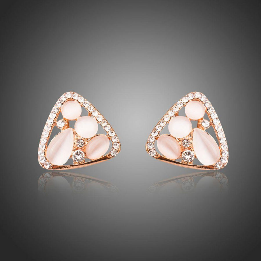 KHAISTA rose gold crystal clip earrings on white background