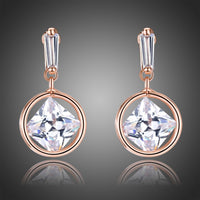 KHAISTA rose gold crystal drop earrings on white background
