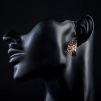 Close up of KHAISTA rose gold Stellux Austrian stud earrings