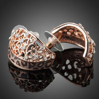 Side angle view of KHAISTA rose gold Stellux Austrian stud earrings