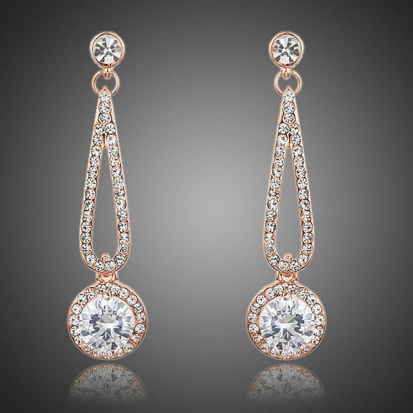 KHAISTA rose gold CZ drop earrings on white background