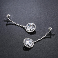 Side angle view of KHAISTA round AAA CZ drop earrings