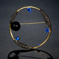 Close-up of blue CZ and black pearl on Khaista celestial brooch
