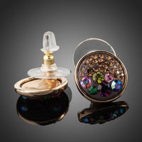 Close up of KHAISTA round chocolate crystal stud earrings