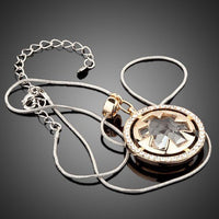 Side angle view of KHAISTA round circle crystal pendant necklace