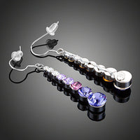 Close up of KHAISTA round crystal drop earrings