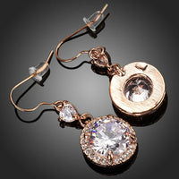 Close up of KHAISTA round CZ fashion drop earrings