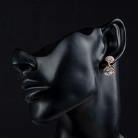 Side angle view of KHAISTA round CZ rhinestone drop earrings