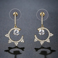 Close up of KHAISTA round crystal dangle earrings
