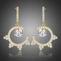 KHAISTA round crystal dangle earrings on white background
