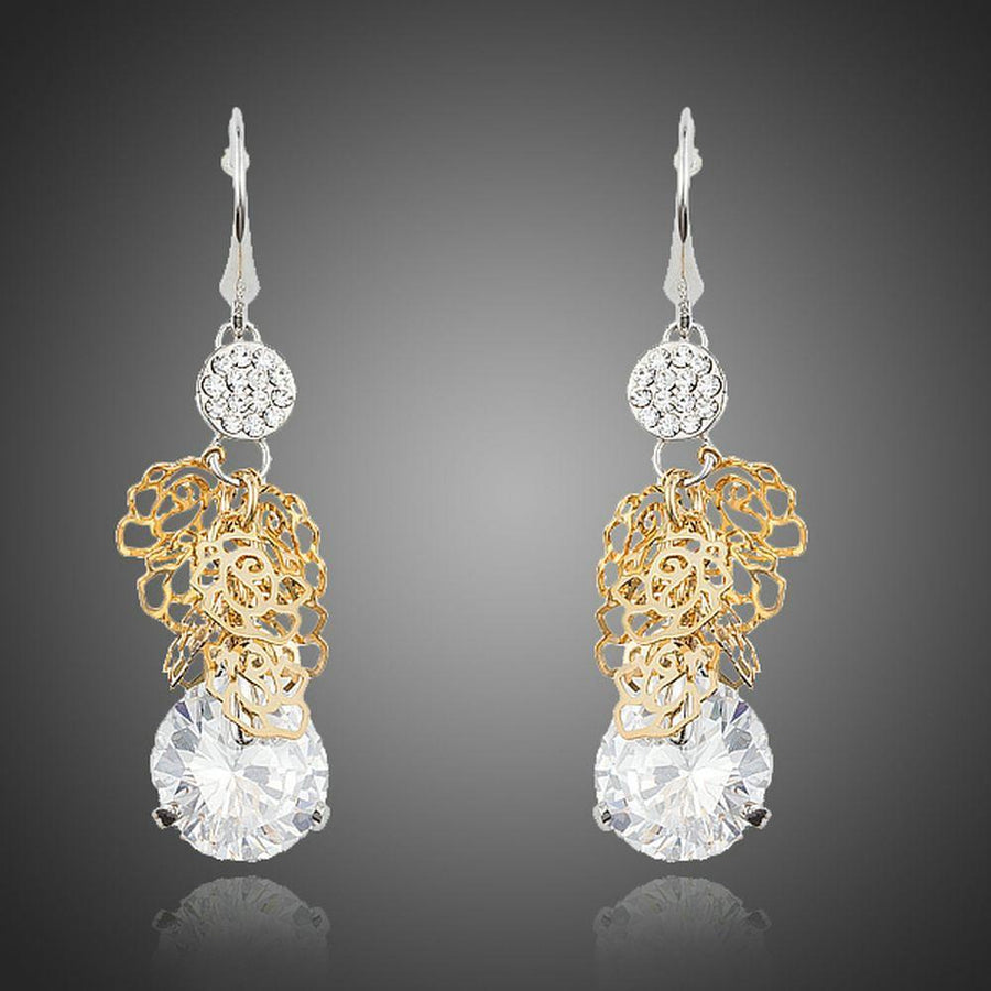 KHAISTA round dangling CZ drop earrings on white background