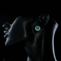 Side angle view of KHAISTA round deep sea crystal stud earrings