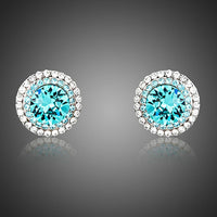 KHAISTA round deep sea crystal stud earrings on white background