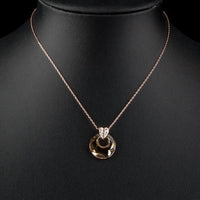 Side angle view of KHAISTA round link chain crystal necklace