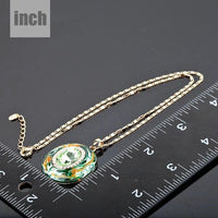 Pendant detail on KHAISTA round ocean waves crystal pendant necklace