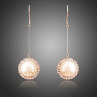 KHAISTA round pearl earrings on white background