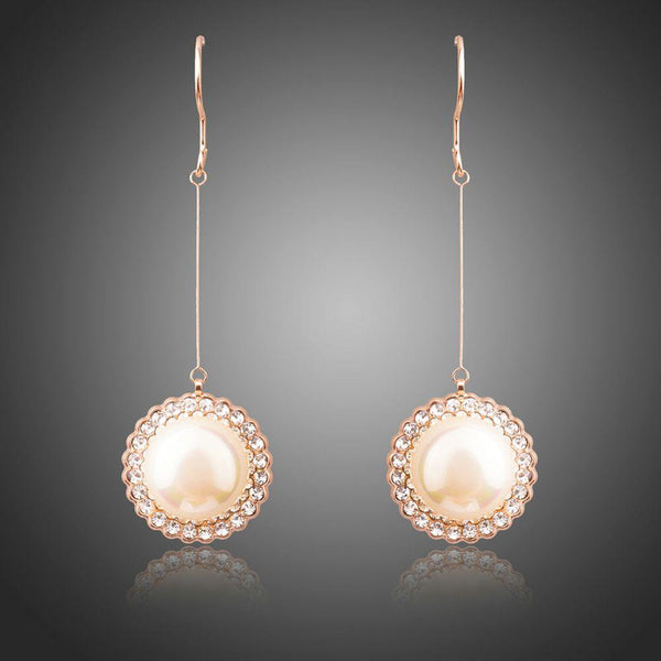KHAISTA round pearl earrings on white background