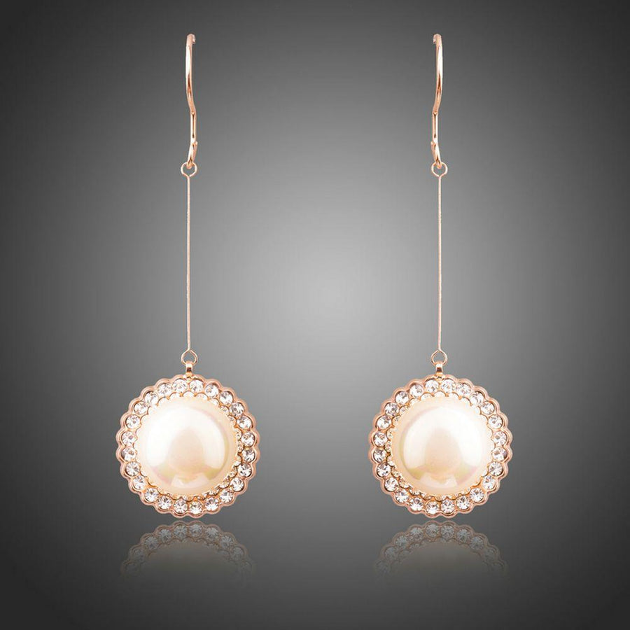 KHAISTA round pearl earrings on white background