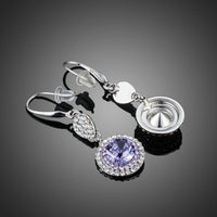 Close up of KHAISTA round purple CZ drop earrings