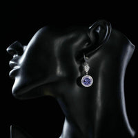 Side angle view of KHAISTA round purple CZ drop earrings