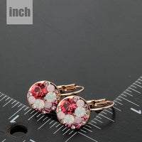 deep red round crystal clip earrings detail view by KHAISTA