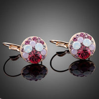 Close up of KHAISTA deep red round crystal clip earrings