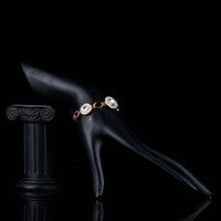 Side angle view of KHAISTA round rhinestone link chain bracelet