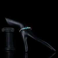Side angle view of KHAISTA sea blue round crystal stud bracelet