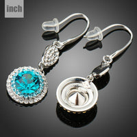 Side angle view of KHAISTA round sea blue crystal hook drop earrings