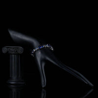 Side angle view of KHAISTA royal blue CZ toggle bracelet