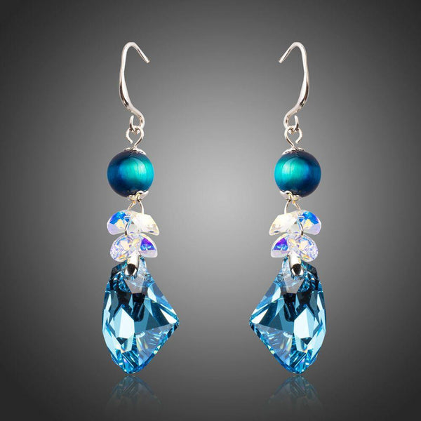 KHAISTA sea blue crystal drop earrings on white background