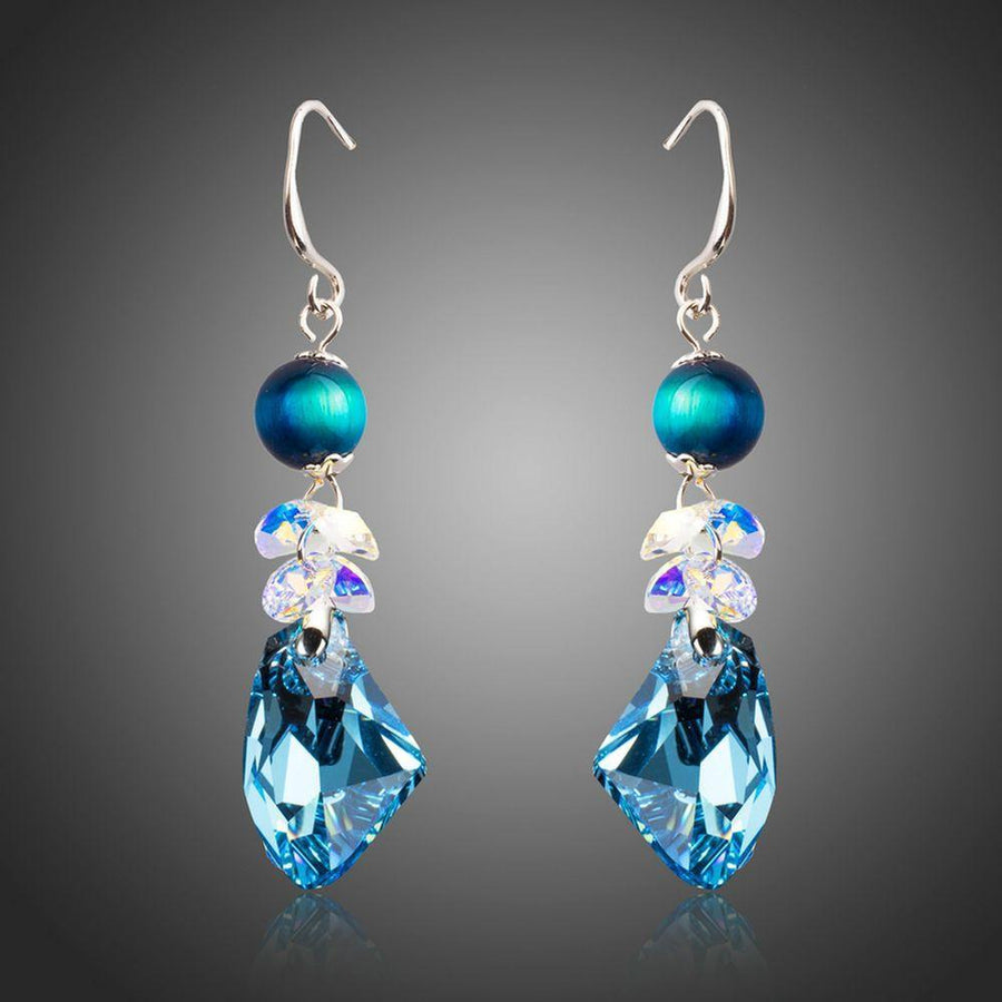 KHAISTA sea blue crystal drop earrings on white background