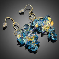 Close up of KHAISTA sea blue crystal drop earrings