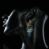 Side angle view of KHAISTA sea blue crystal drop earrings