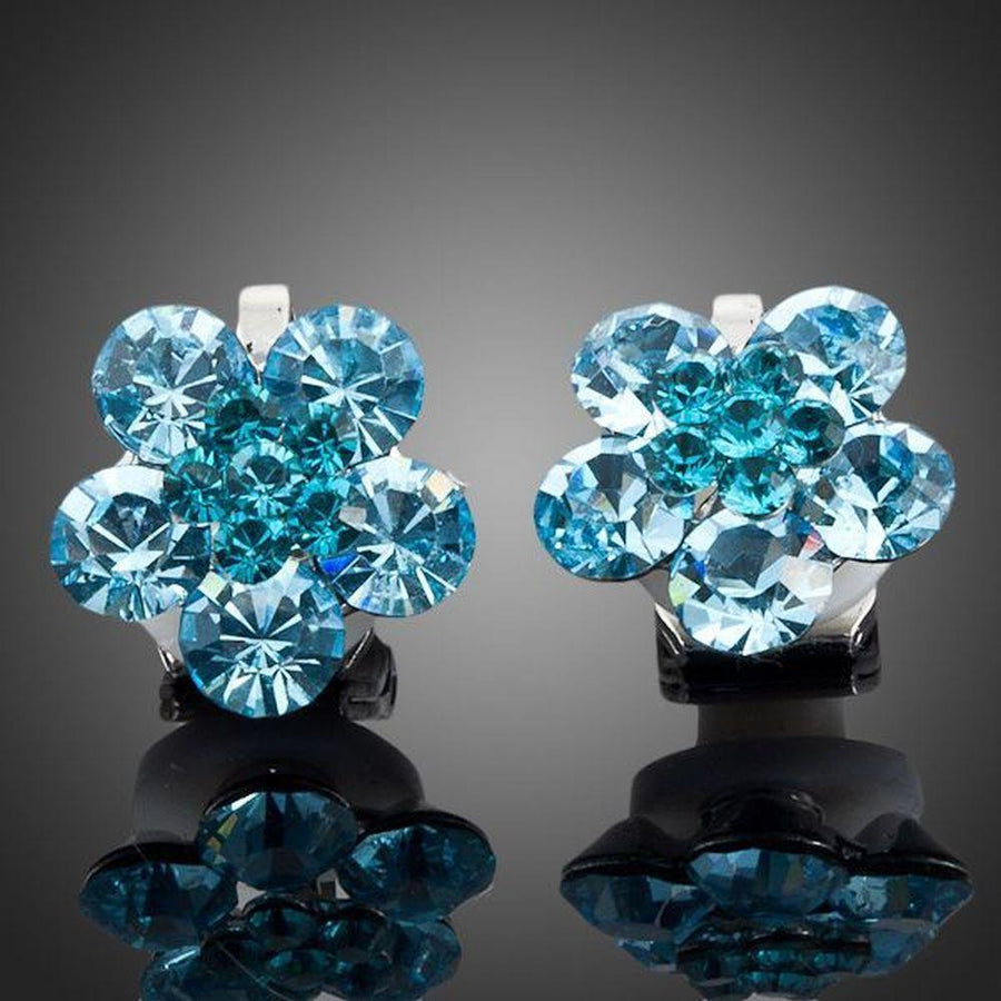 KHAISTA sea blue crystal flower stud earrings on white background