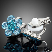 Close up of KHAISTA sea blue crystal flower stud earrings