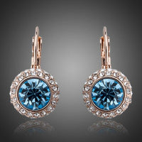 KHAISTA sea blue round crystal earrings on white background