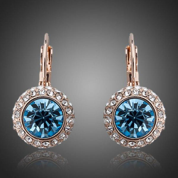 KHAISTA sea blue round crystal earrings on white background