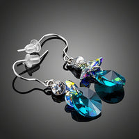 Close up of KHAISTA sea blue rhinestone crystal drop earrings