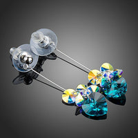 Close up of KHAISTA sea blue rhinestone heart drop earrings