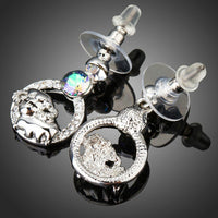 Side angle view of KHAISTA crystal sheep design dangle earrings