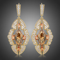 KHAISTA Austrian crystal shield dangle earrings on white background