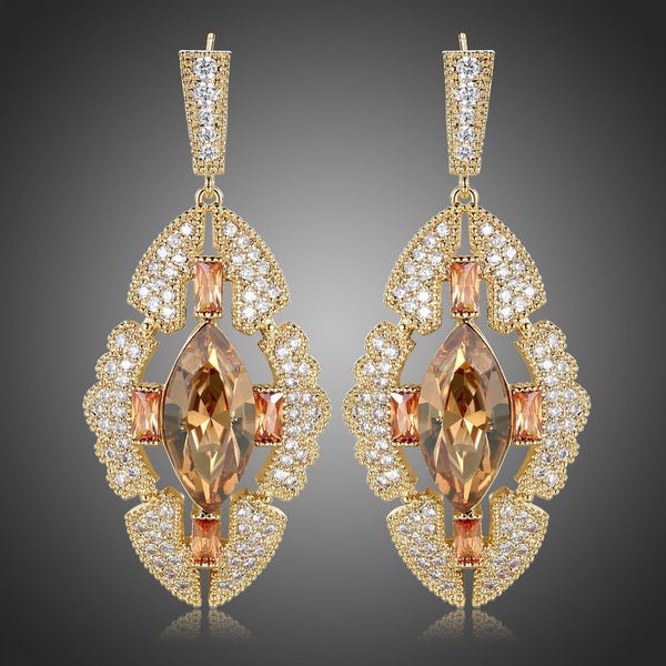 KHAISTA Austrian crystal shield dangle earrings on white background