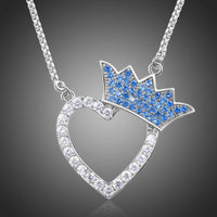 Close up detail of KHAISTA silver heart crown CZ pendant necklace