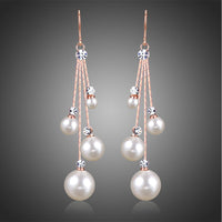 KHAISTA pearl chain dangle hook earrings on white background