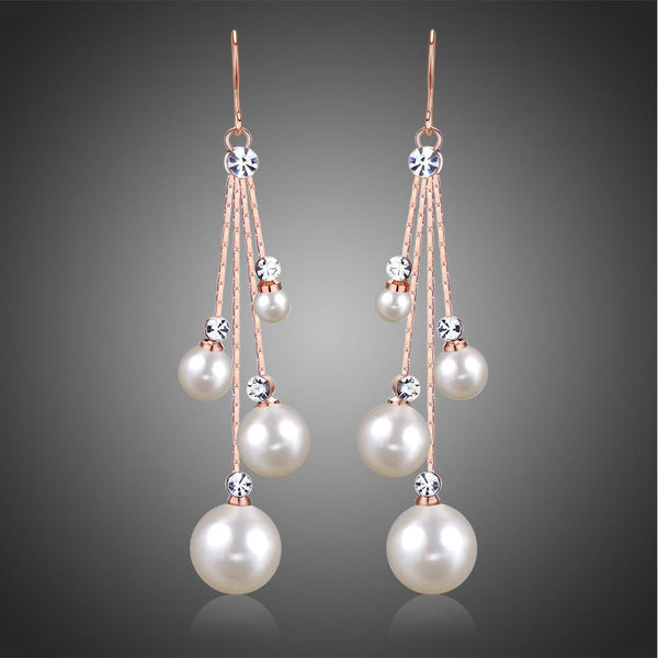 KHAISTA pearl chain dangle hook earrings on white background