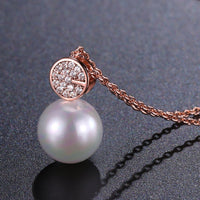 Pendant detail on KHAISTA simulated pearl dazzling pendant necklace
